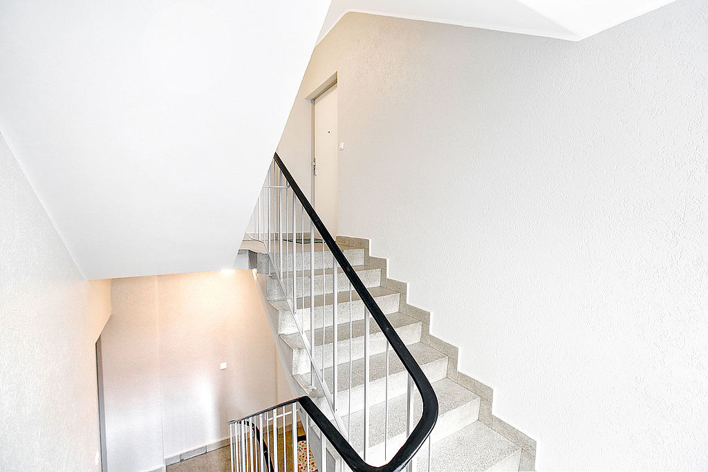 Frisch renoviertes, weiß gestrichenes Treppenhaus